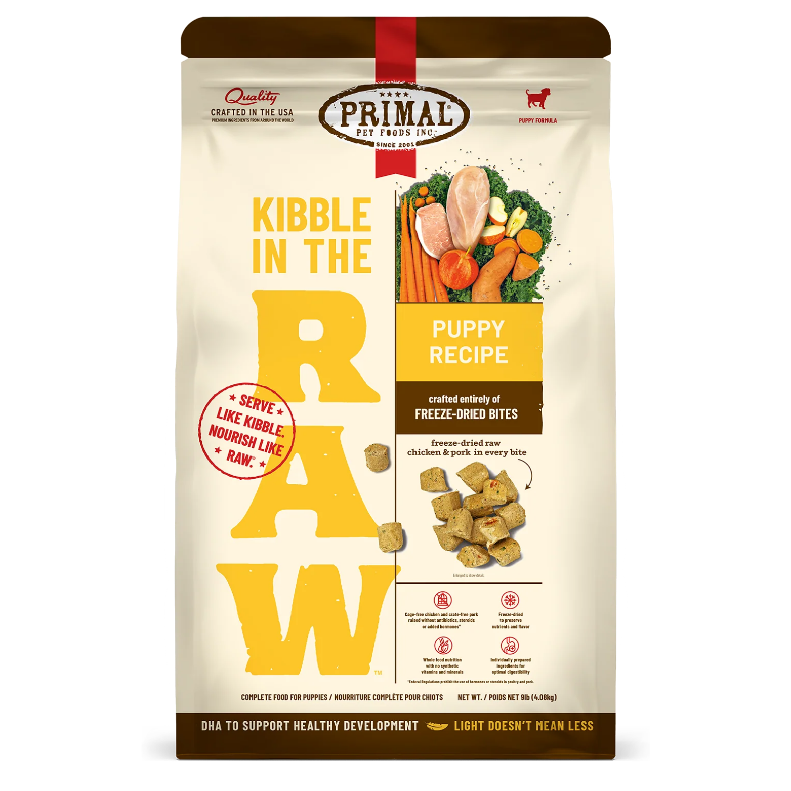 Front of a Primal Pet Foods “Kibble in the Raw” Puppy Recipe dog food bag. The cream-colored package features large yellow “RAW” lettering, images of chicken, pork, and vegetables, and text indicating it is crafted from freeze-dried bites with DHA for healthy development. Net weight shown as 9 lb (4.08 kg).