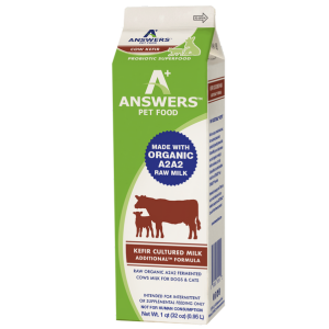 Front view of a green and white carton of Answers Pet Food raw organic A2 cow milk kefir for dogs. The packaging labels the product as a probiotic superfood made with organic A2 raw milk and kefir-cultured milk, intended for supplemental feeding only. The carton contains one quart (32 ounces) and features branding, nutritional claims, and animal icons.