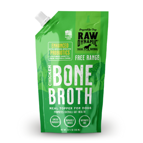 Green spouted pouch of Raw Dynamic dog bone broth labeled “Chicken Bone Broth.” The package has a white twist cap at the top corner and a darker green panel with the Raw Dynamic logo. Text reads “Enhanced with species-specific probiotics,” “Free Range,” and “Meal topper for dogs promotes overall gut health.” Icons indicate “Limited ingredients,” “Humanely raised,” and “Antibiotic free.” Net weight is 12 fl oz (355 mL).
