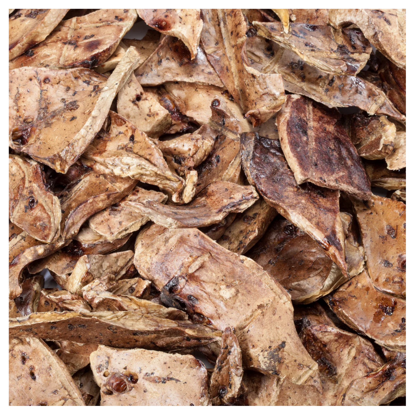 Detailed close-up of dehydrated lamb lung slices in various irregular shapes and brown tones, showing porous texture and dried surface.