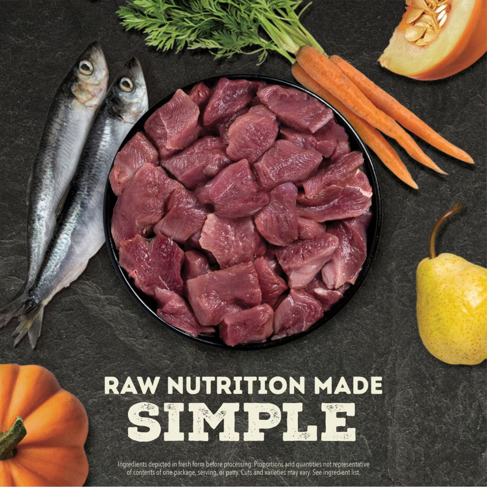Bowl of raw duck meat chunks surrounded by carrots, pumpkin, pears, and whole fish with text reading ‘Raw Nutrition Made Simple.’