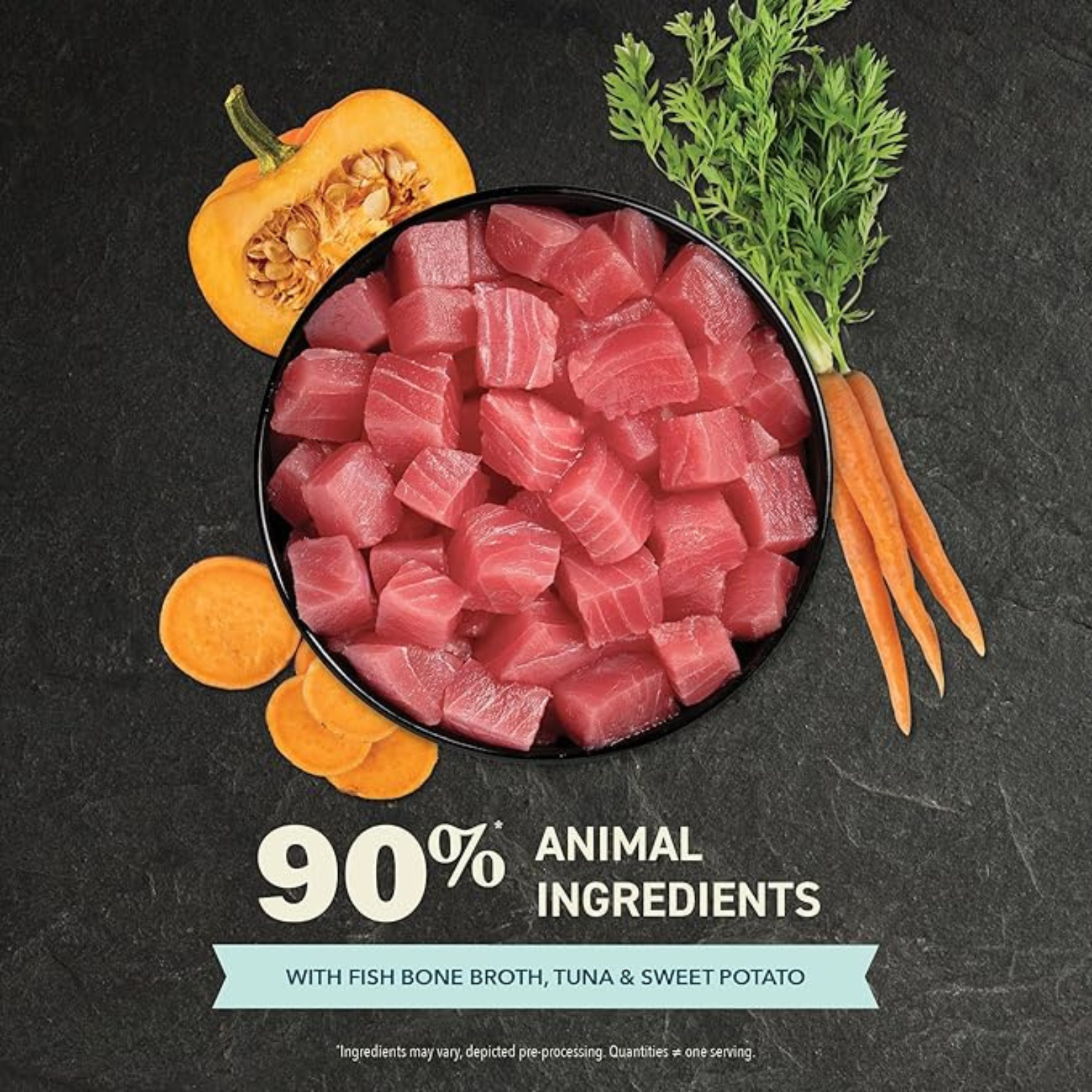 Bowl filled with raw tuna cubes surrounded by pumpkin, carrots, and sweet potato slices, with text stating ‘90% animal ingredients’ and ‘with fish bone broth, tuna, and sweet potato.