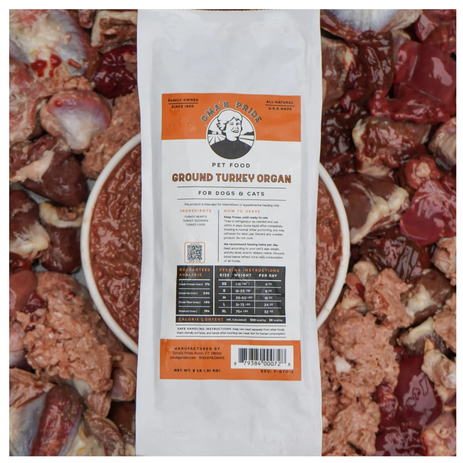 A package of Oma’s Pride Ground Turkey Organ frozen pet food positioned on top of raw turkey organs and ground mixture.