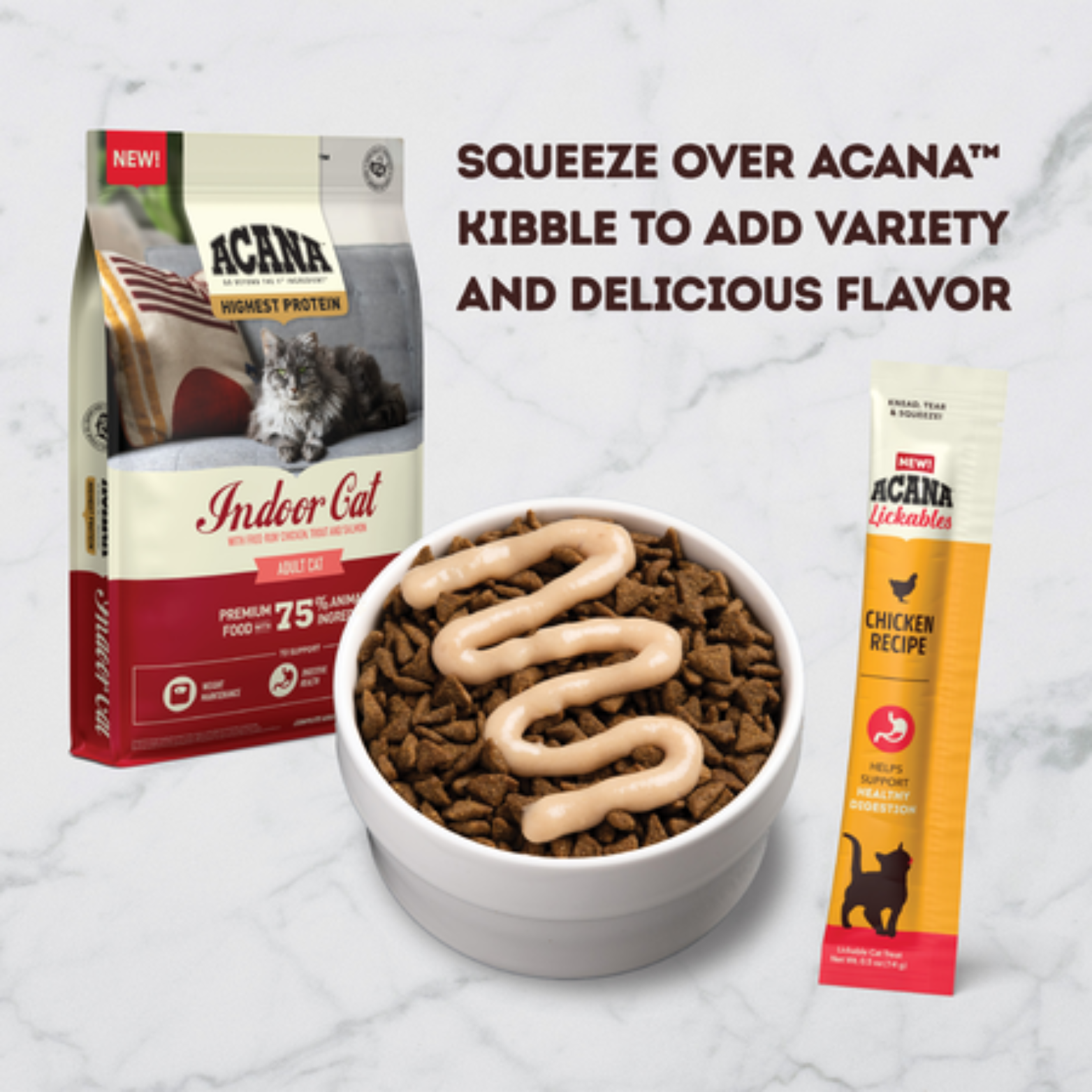 Bowl of dry cat kibble topped with a zigzag drizzle of creamy chicken lickable treat, shown beside an ACANA Indoor Cat kibble bag and an ACANA Lickables Chicken Recipe sachet on a marble surface.