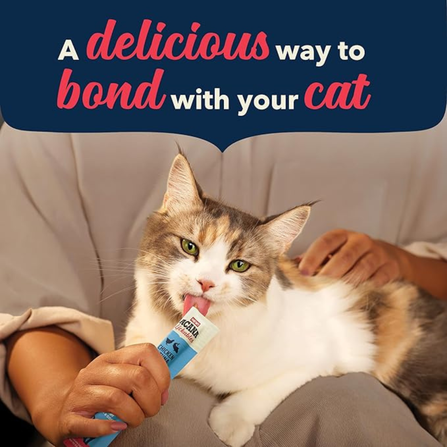 A cat licking an ACANA Lickables Chicken & Tuna Recipe treat from a squeeze tube while resting on a person’s lap, with text reading “A delicious way to bond with your cat.”