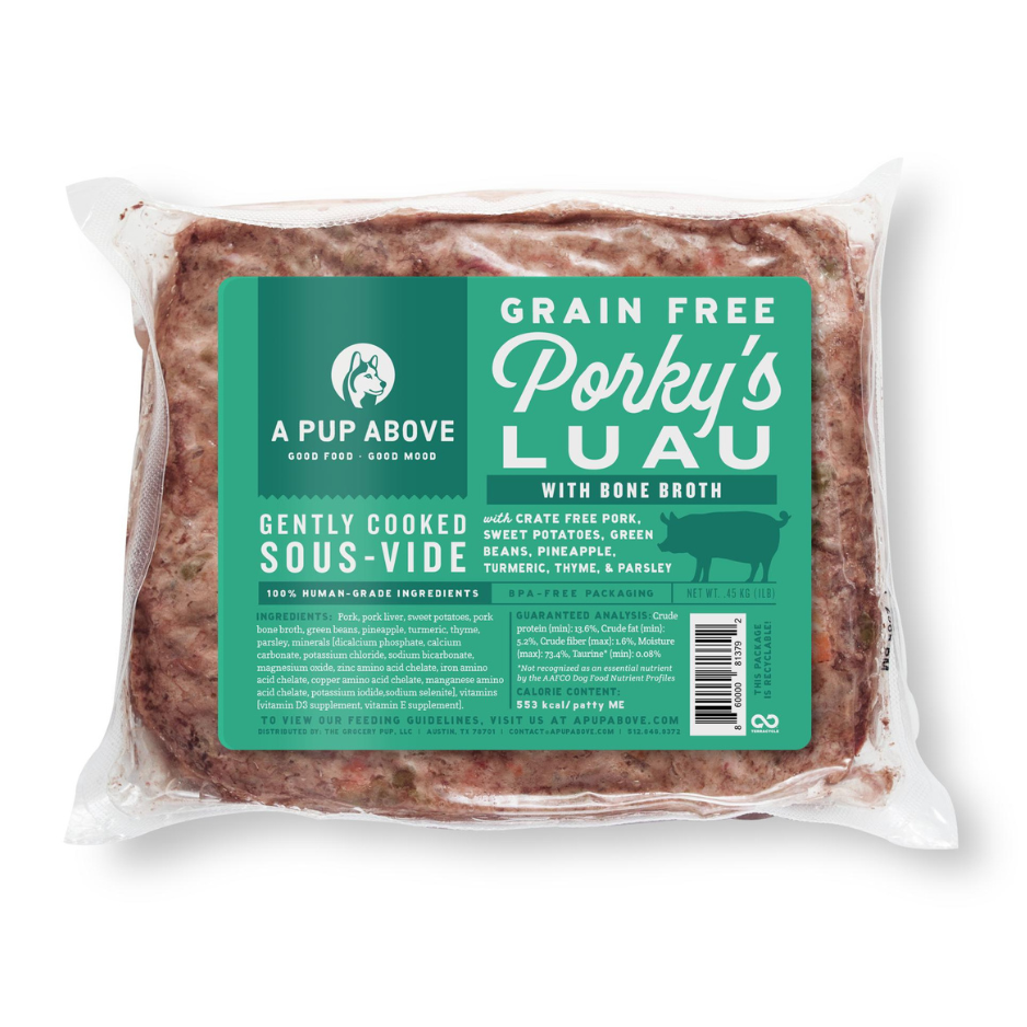 Vacuum-sealed package of A Pup Above Porky’s Luau dog food, featuring a teal label stating it is a grain-free, gently cooked sous-vide recipe made with crate-free pork, bone broth, sweet potatoes, green beans, pineapple, turmeric, thyme, and parsley.