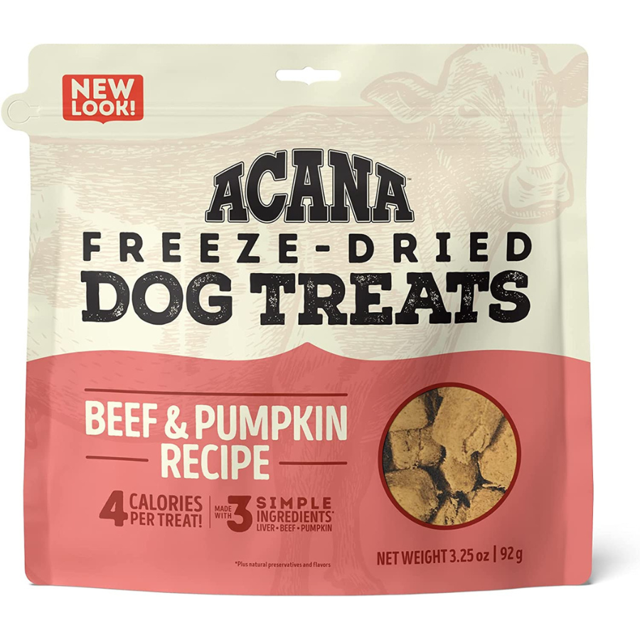 The front of a bag of Acana Freeze-Dried Dog Treats, Beef & Pumpkin Recipe. The top of the bag is cream-colored with a faint outline of a cow, and the bottom features a wavy red section. Text highlights include "4 calories per treat!" and "Made with 3 simple ingredients: Liver, Beef, Pumpkin." A small red banner in the corner reads "NEW LOOK!" The net weight is listed as 3.25 oz (92 g).